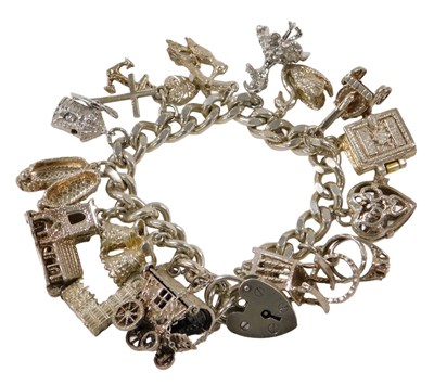 Lot 290 - A silver curb link charm bracelet, with...