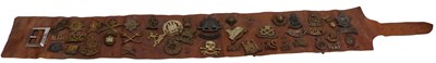 Lot 294 - A brown military belt, holding assorted cap...