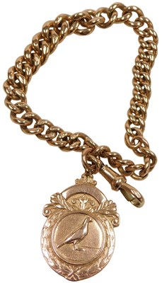 Lot 393 - A 9ct rose gold racing pigeon medallion, on a...