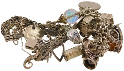 Lot 394 - A silver curb link charm bracelet, with a...