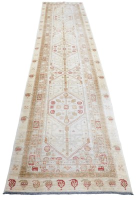Lot 406 - A Persian Scrab cream ground runner, the...