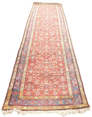 Lot 408 - A Tabriz red ground runner, the central field...