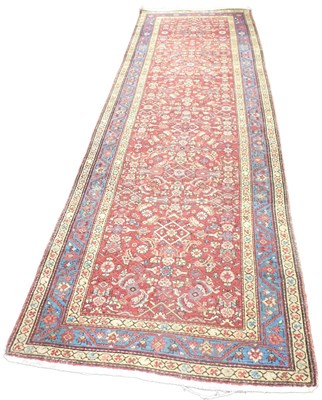 Lot 410 - A Kashan red ground runner, the central field...