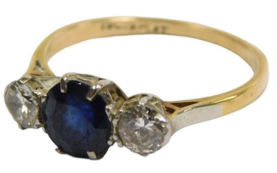 Lot 413 - A sapphire and diamond three stone ring, the...