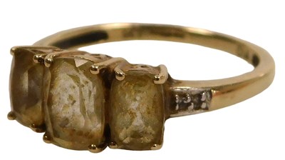 Lot 427 - A 9ct gold and citrine three stone ring, the...