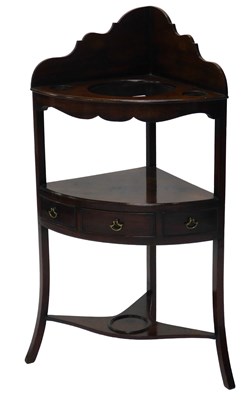 Lot 23 - A George III mahogany corner washstand, with a...