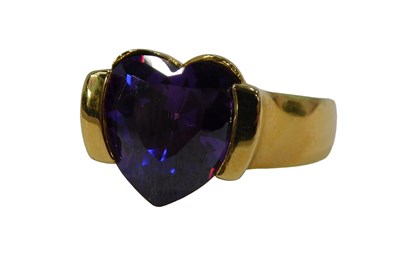 Lot 312 - An amethyst dress ring, set with fancy cut...