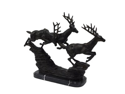 Lot 125 - A spelter figure group of running stags, in...