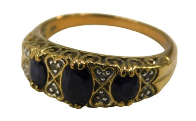 Lot 95 - A 9ct gold garnet and diamond half hoop dress...