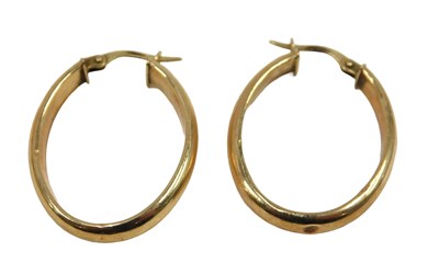 Lot 70 - A pair of hoop earrings, each of oval plain...