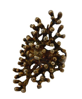 Lot 73 - An abstract dress ring, formed as coral, with...