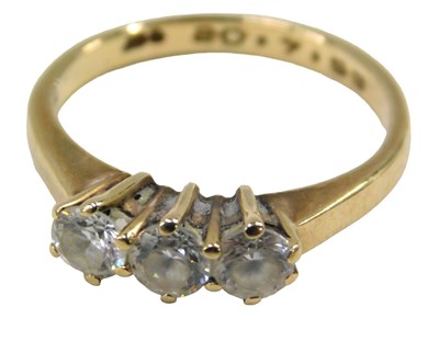 Lot 51 - A 9ct gold three stone dress ring, set with...