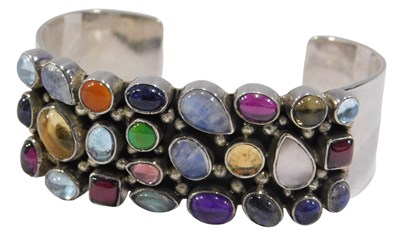 Lot 353 - A multi-stone link bangle, the rectangular...