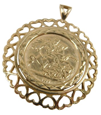 Lot 665 - A 9ct gold coin pendant, set with George and...