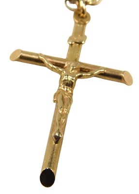Lot 670 - A 9ct gold crucifix pendant and chain, the...