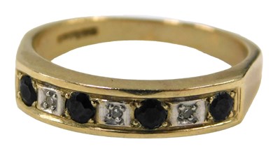Lot 679 - A 9ct gold half hoop dress ring, set with four...