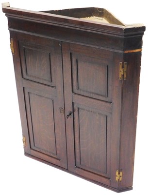 Lot 846 - An early 19thC oak panelled hanging corner...