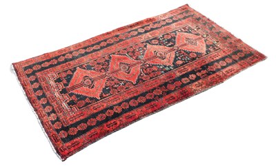 Lot 1134 - A Middle Eastern style machine woven rug, of...