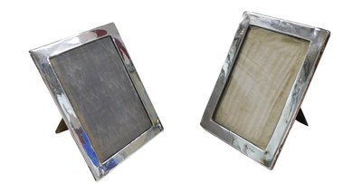 Lot 1149 - A matched pair of George V silver frames, each...