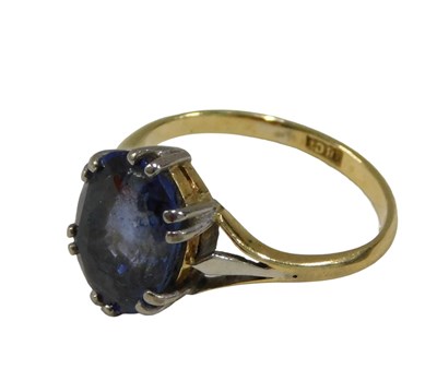 Lot 1156 - A lady's dress ring, claw set with blue stone,...